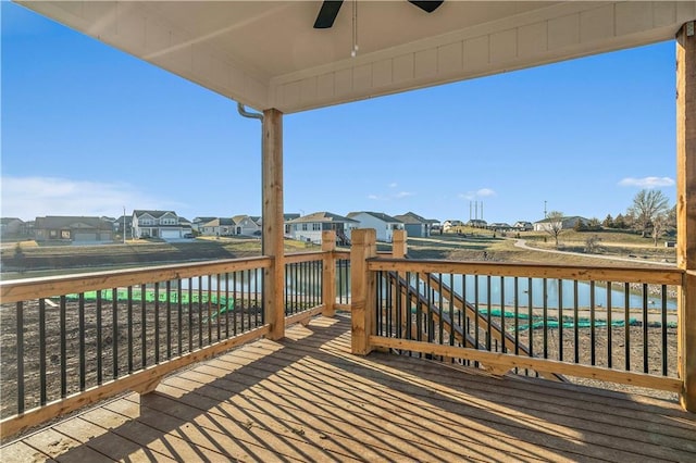 wooden terrace featuring a water view and ceiling fan