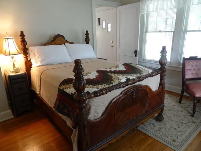 bedroom featuring light wood finished floors and baseboards