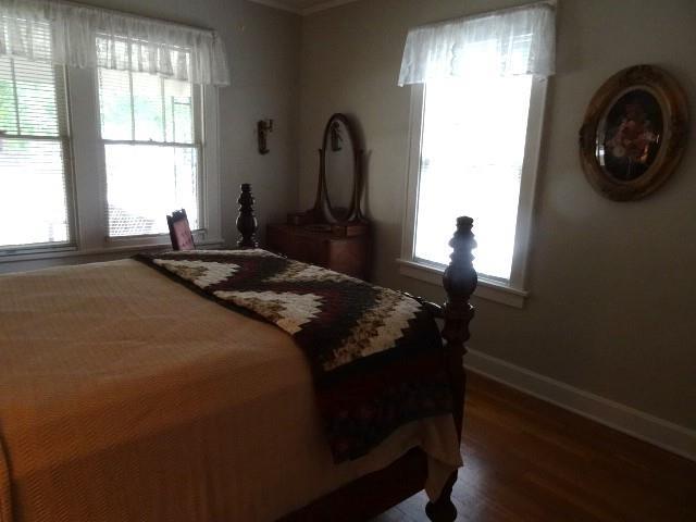 bedroom with wood-type flooring