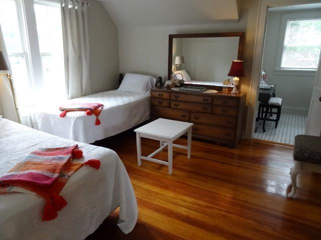 bedroom with lofted ceiling and wood finished floors