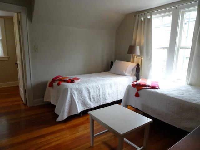 bedroom with lofted ceiling and wood finished floors