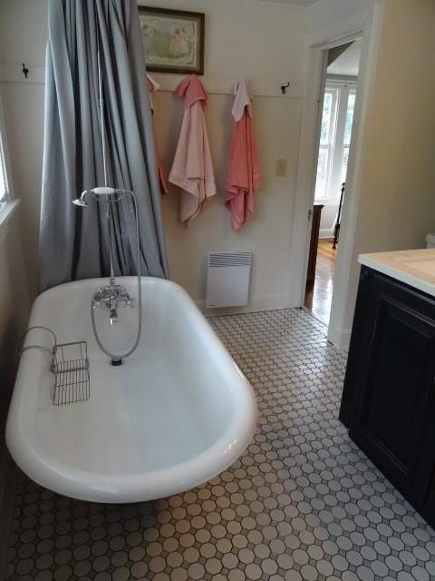 bathroom featuring a freestanding bath and vanity