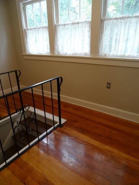 stairs featuring wood finished floors and baseboards