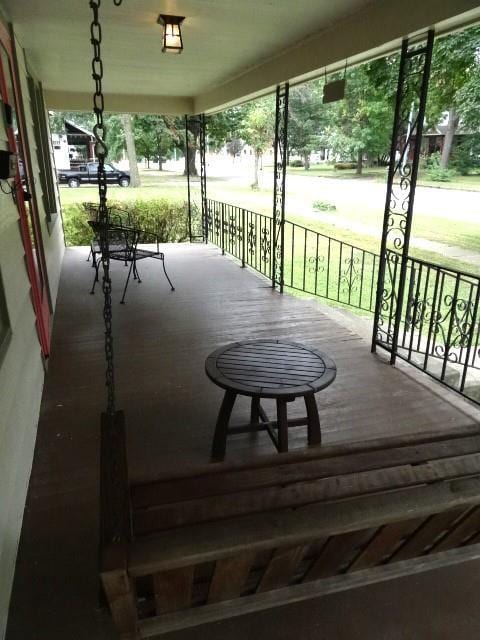 wooden terrace featuring covered porch