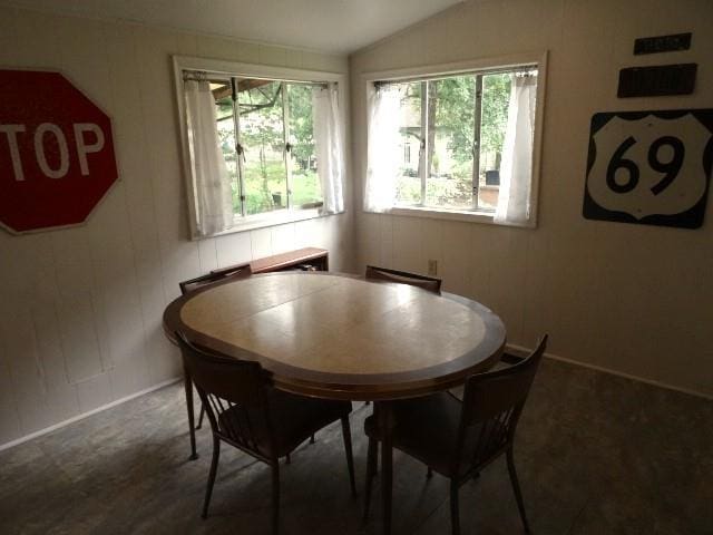 dining area with plenty of natural light and lofted ceiling