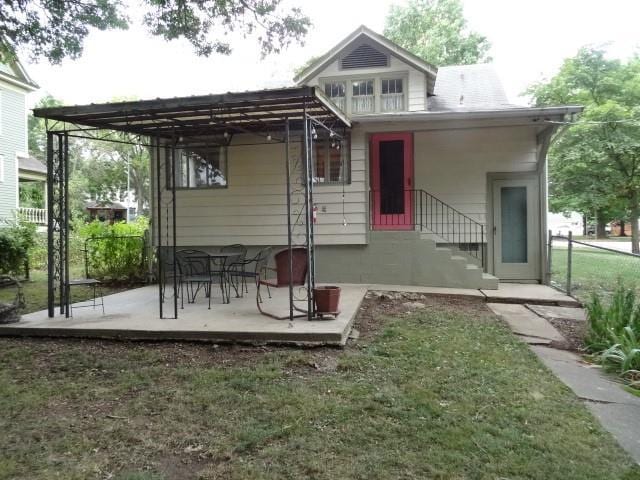 rear view of house with a yard