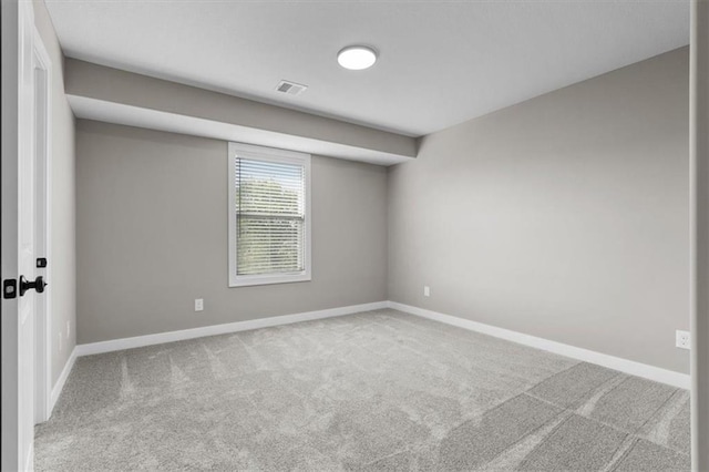 empty room featuring baseboards and carpet floors