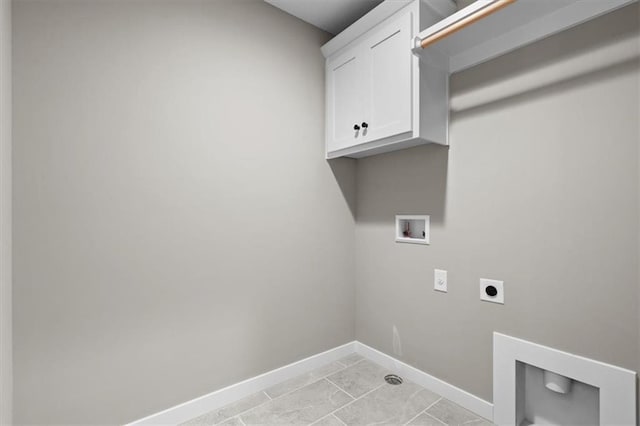 clothes washing area featuring cabinet space, electric dryer hookup, hookup for a washing machine, and baseboards