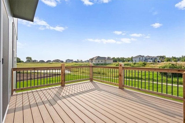 wooden deck featuring a lawn