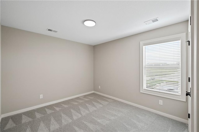 carpeted empty room with a healthy amount of sunlight