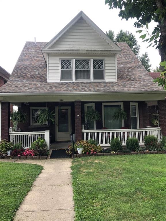 view of front of home featuring a front yard and a porch