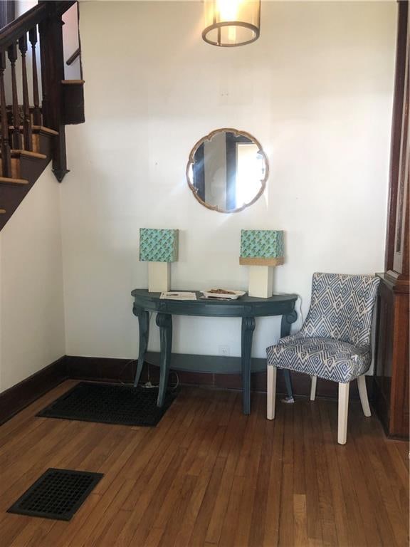 sitting room with dark wood-type flooring