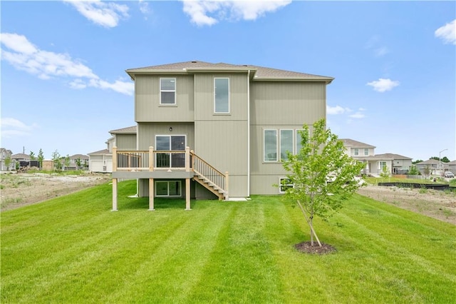 back of house featuring stairs, a lawn, and a wooden deck