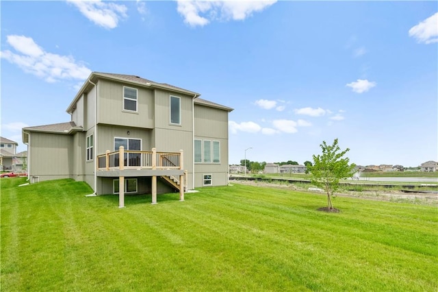 rear view of house with a yard and a deck