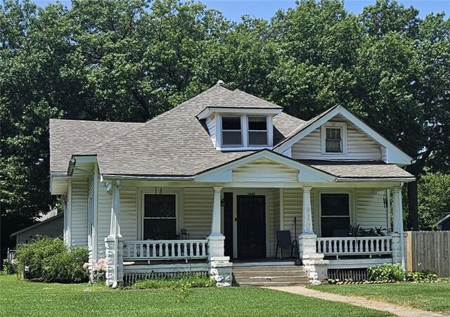 view of front of property with a front yard and a porch