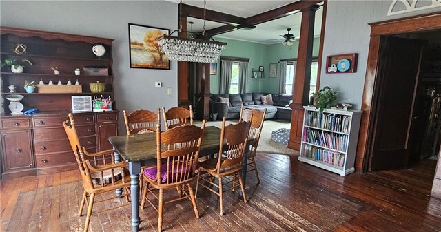 dining space with decorative columns, ceiling fan, beamed ceiling, and dark hardwood / wood-style floors