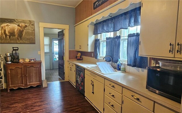 kitchen with ornamental molding, sink, dark wood-type flooring, and black dishwasher