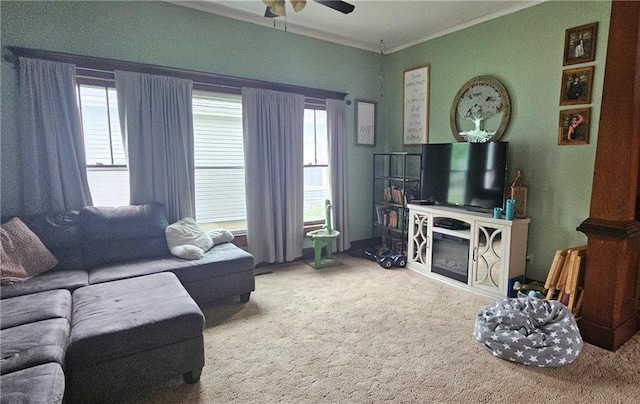 living room featuring ceiling fan, carpet floors, crown molding, and a healthy amount of sunlight