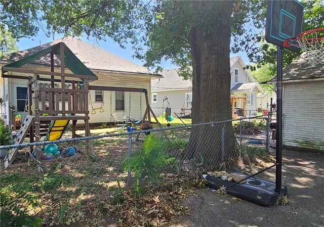 rear view of property with a playground