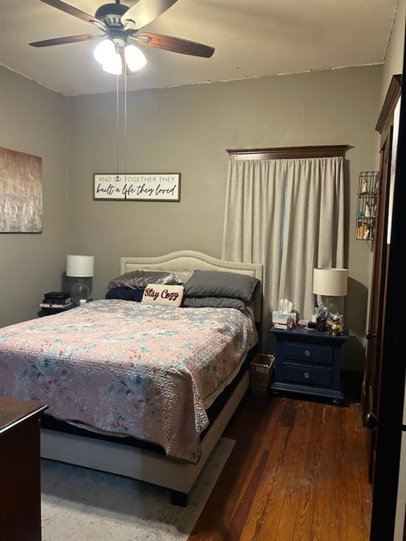 bedroom featuring ceiling fan and dark wood-type flooring