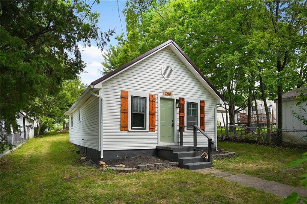 bungalow-style home featuring a front yard