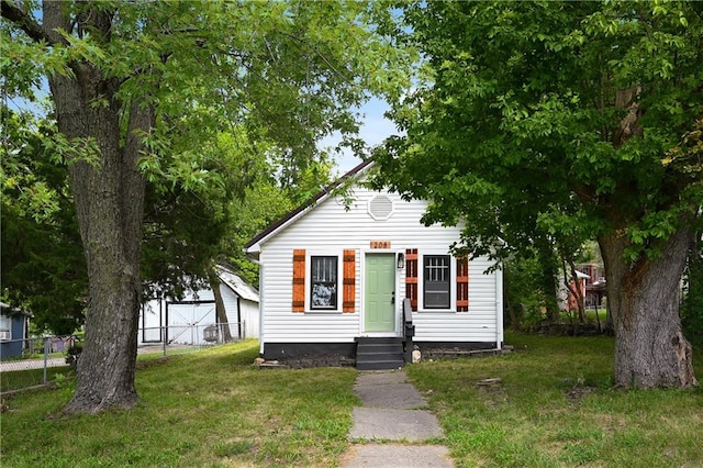 bungalow-style house featuring a front yard