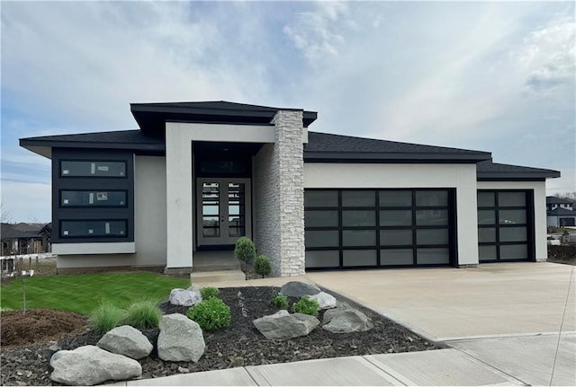 view of front of house featuring concrete driveway, french doors, an attached garage, and stucco siding