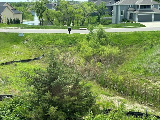 view of yard with a garage and a water view