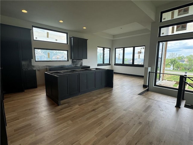 kitchen featuring dark cabinetry, recessed lighting, light wood-style flooring, and a healthy amount of sunlight