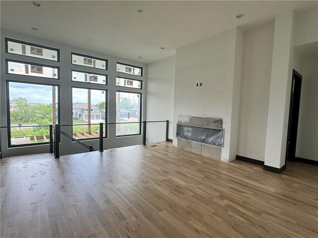 unfurnished room featuring hardwood / wood-style floors and a healthy amount of sunlight