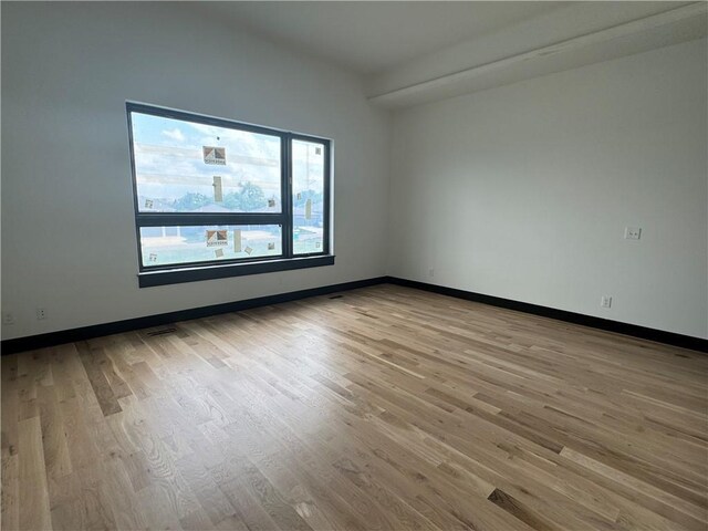 empty room with light hardwood / wood-style floors