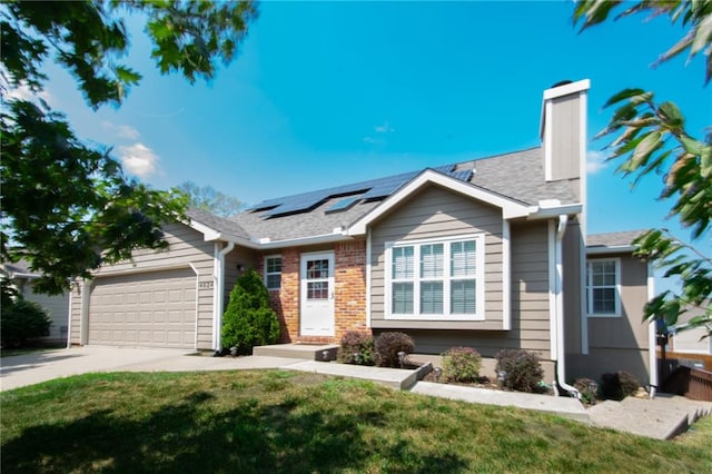 view of front of house featuring a garage, a front yard, and solar panels