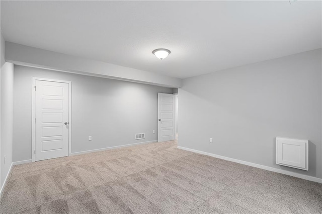 basement featuring light carpet