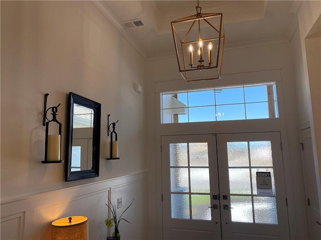 16445 S Elmridge St, Olathe, KS 66062 - doorway featuring crown molding, visible vents, a chandelier, wainscoting, and french doors