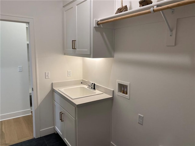16445 S Elmridge St, Olathe, KS 66062 - clothes washing area featuring dark wood-style flooring, baseboards, hookup for a washing machine, cabinet space, and a sink