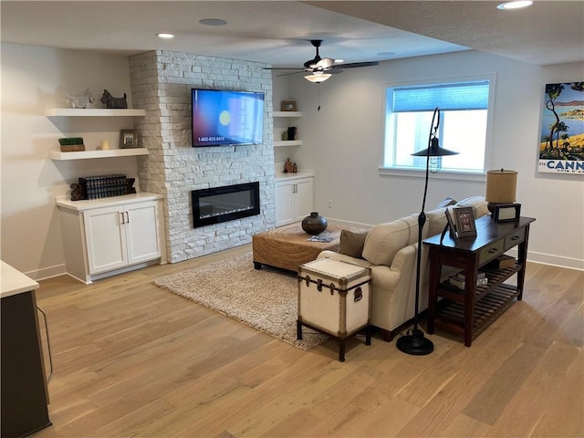 16445 S Elmridge St, Olathe, KS 66062 - living room featuring baseboards, recessed lighting, a fireplace, light wood-style flooring, and ceiling fan