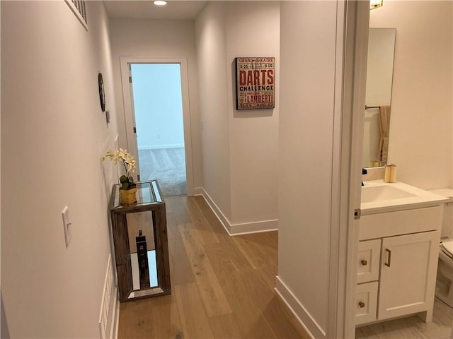 16445 S Elmridge St, Olathe, KS 66062 - corridor featuring light wood-type flooring, visible vents, recessed lighting, a sink, and baseboards