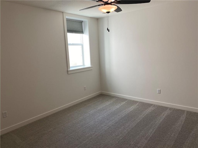16445 S Elmridge St, Olathe, KS 66062 - spare room with dark colored carpet, baseboards, and ceiling fan