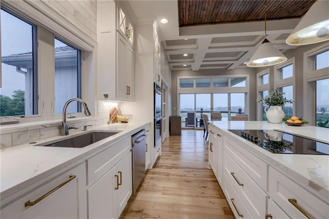 kitchen with white cabinets, pendant lighting, sink, and black electric cooktop