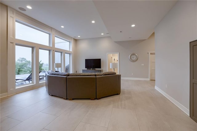 tiled living room featuring a high ceiling