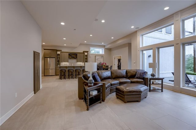 living room featuring a high ceiling and a wealth of natural light