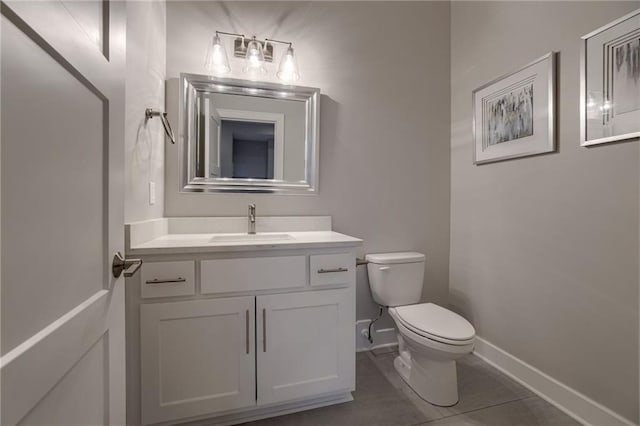 bathroom featuring toilet, tile patterned floors, and vanity