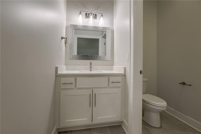 bathroom featuring toilet and vanity