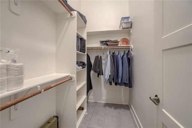 spacious closet featuring light tile patterned flooring