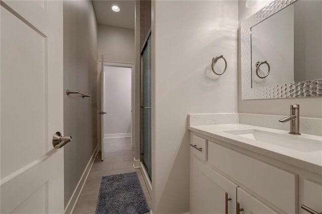 bathroom with vanity, an enclosed shower, and tile patterned floors