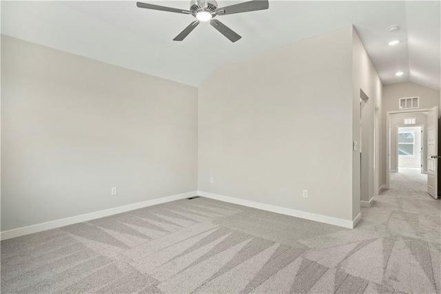 unfurnished room featuring lofted ceiling, carpet floors, visible vents, and baseboards