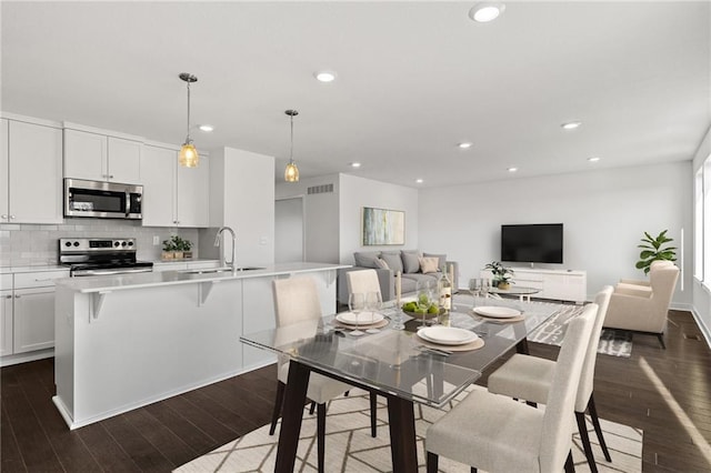 dining area with dark wood-type flooring, recessed lighting, and visible vents