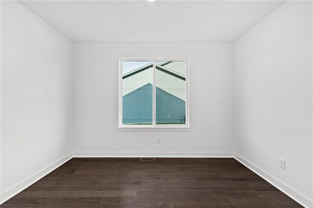 unfurnished room featuring plenty of natural light and hardwood / wood-style floors