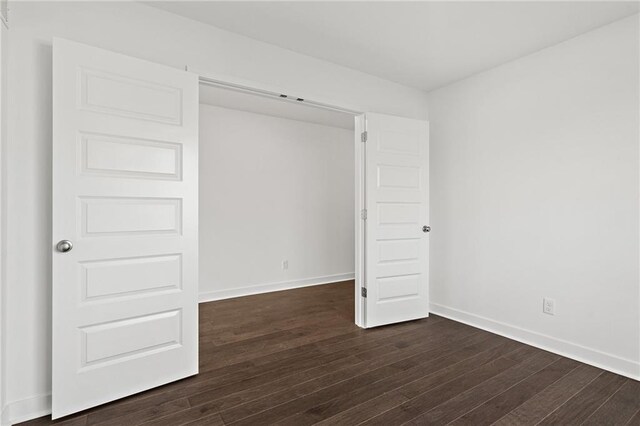 spare room with dark wood-type flooring