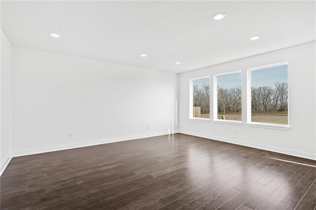 spare room with dark wood-type flooring